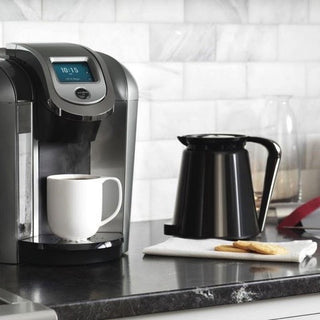 Single serve coffee brewer, carafe, and cookies