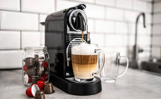 A coffee machine making coffee next to a char full of K-Cups